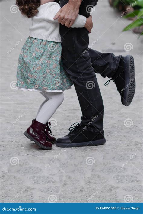 Legs of the Father and Child in White Pants. Child Stands Next To ...