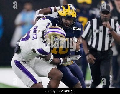 Michigan Wolverines quarterback Alex Orji (10) carries the ball as ...