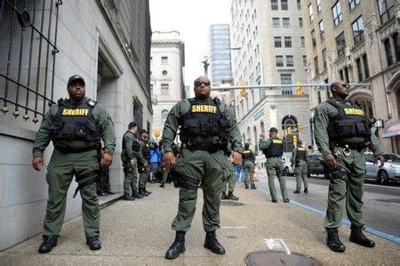 City Sheriff Deputies stand outside of the courthouse in Baltimore - Standard News