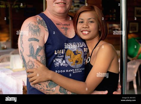 Thailand, Pattaya, Bar Girl Hugging Tatooed Male Tourist who is Stock Photo: 8791307 - Alamy