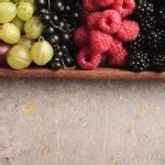 Summer wild berry fruits on vintage board still life concept Stock Photo by ©udra 50109001