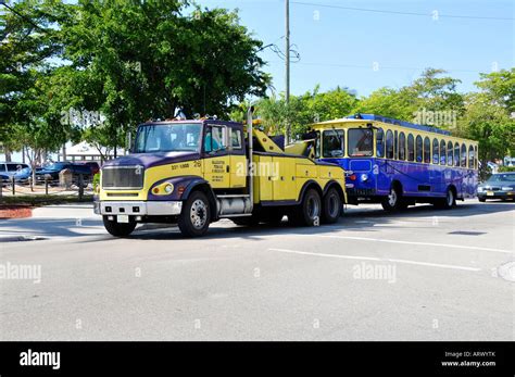 Broken down bus being towed by a tow truck for repair Stock Photo - Alamy