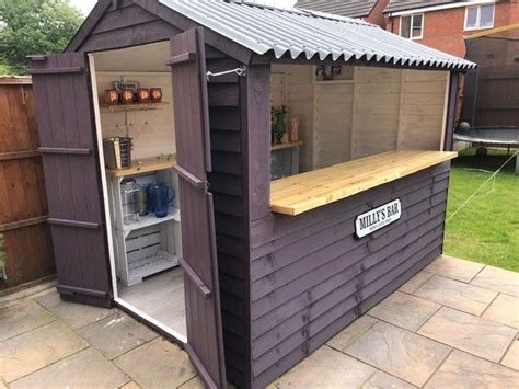 A purple shed transformed into a bar with DIY roofing Rustic Outdoor Bar, Rustic Shed, Outdoor ...