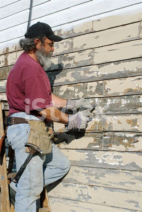 Man Scraping Paint from House stock photos - FreeImages.com