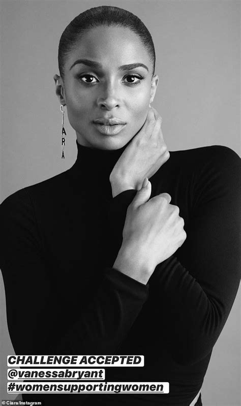 a woman with her arms crossed posing for a magazine advertiser's photo