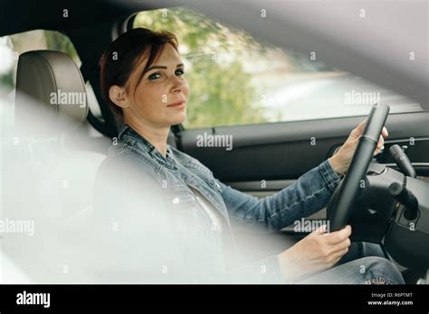 Middle age woman driving SUV car in traffic Stock Photo - Alamy