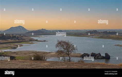 Early morning view of Jawai dam with water and morning colors in the sky at Jawai in Rajasthan ...