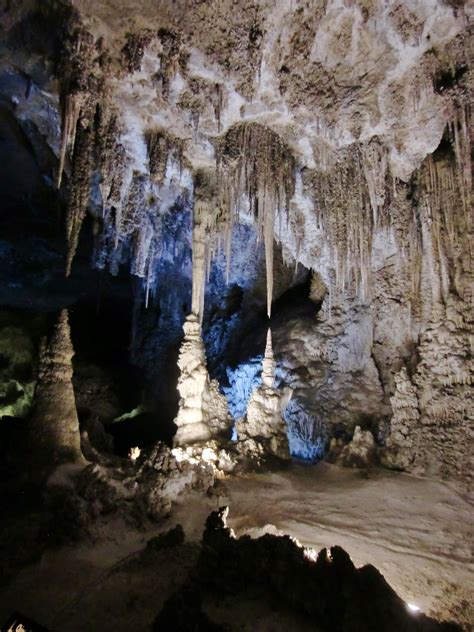 the inside of a cave with ice hanging from it's ceiling