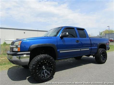 a blue truck parked in front of a building