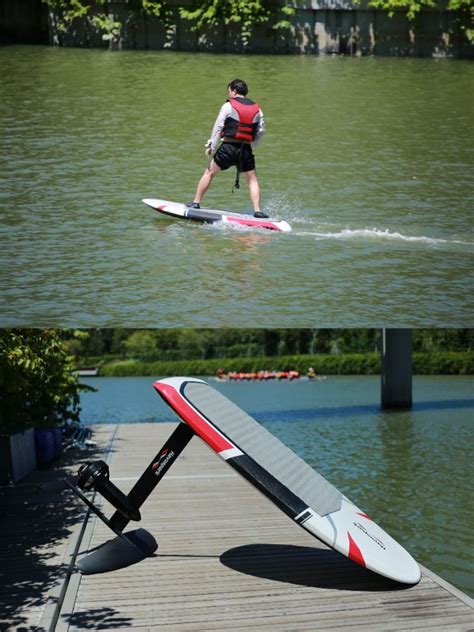 a man riding a surfboard on top of a body of water next to a paddle board