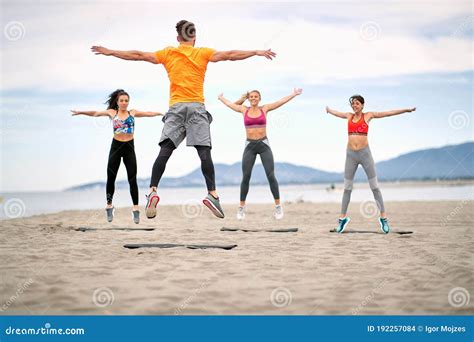 Fitness People Jumping and Fitness Workout on the Beach Stock Photo - Image of beach, fitness ...