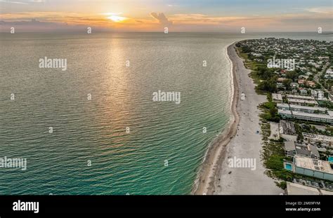 An aerial of Fort Myers beach with a cityscape view at sunset golden ...