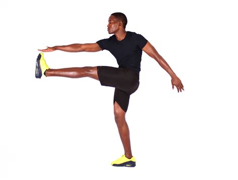 Flexible man doing high kicks exercise