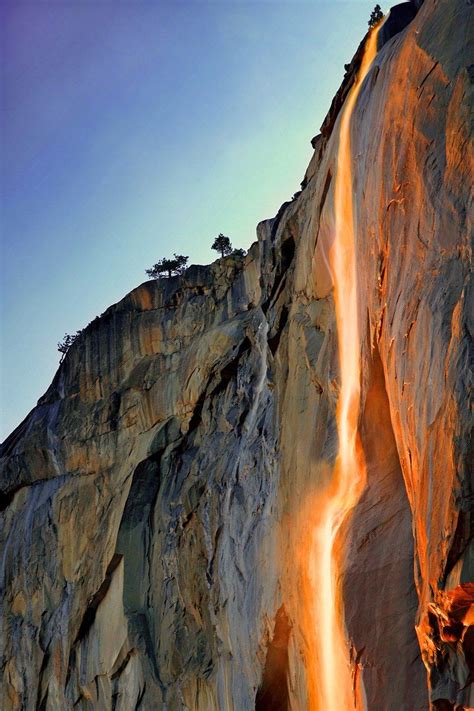 a waterfall is flowing down the side of a mountain