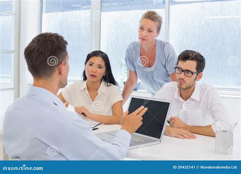 Casual Businessman Using His Laptop during a Meeting Stock Image - Image of colleagues, people ...