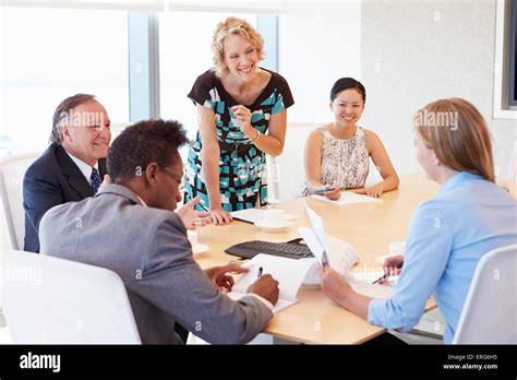 Five Businesspeople Having Meeting In Boardroom Stock Photo - Alamy