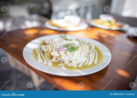 Sunlight on Plate with Delicious Green Mexican Enchiladas Stock Photo ...