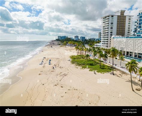 Fort Lauderdale Beach morning after Hurricane Nicole aftermath with cleanup crews removing sand ...