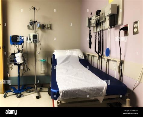 Emergency room hospital bed surrounded by medical equipment Stock Photo ...