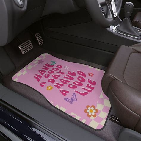 the interior of a car with a pink floor mat that says live love laugh ...