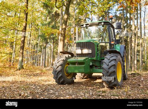 Forestry tractor or forestry tractor for harvesting wood in the forest Stock Photo - Alamy