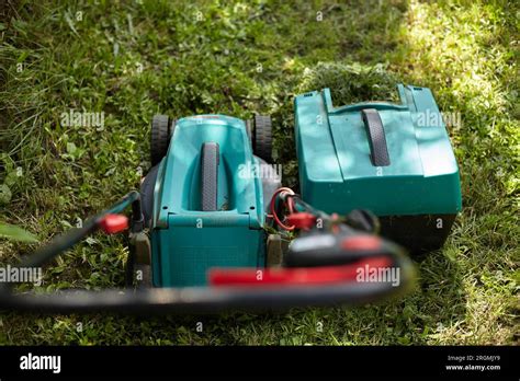 Lawn mower. Lawn mowing. Yard care Stock Photo - Alamy