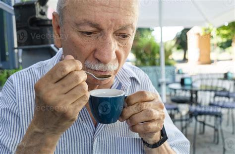 Elderly man drinking espresso coffee at an outdoor cafe 21602436 Stock ...