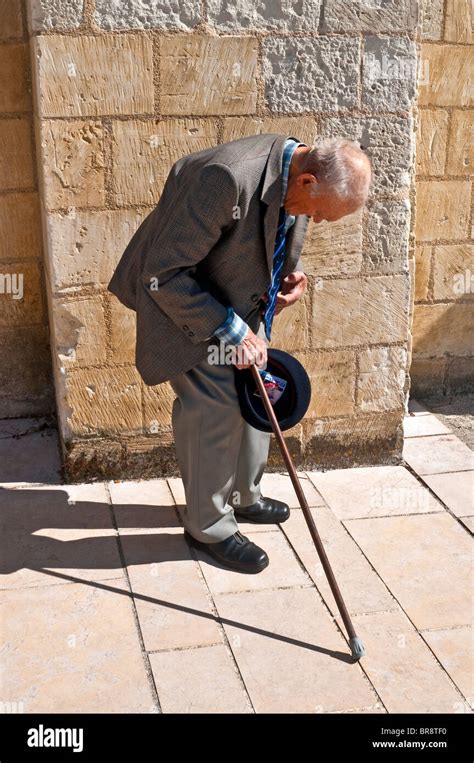 Old man walking bent hi-res stock photography and images - Alamy