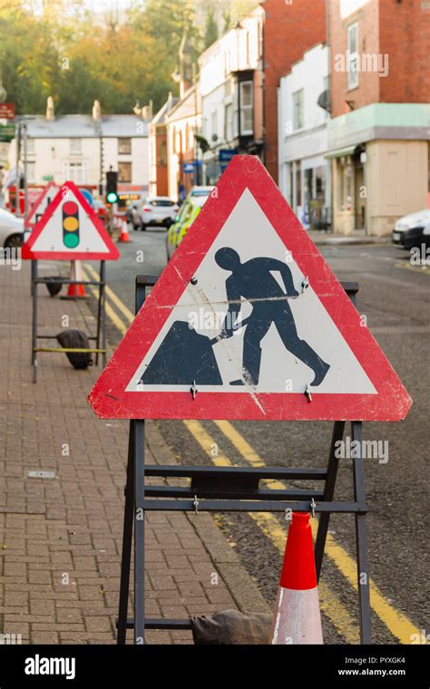 Temporary road works signs and traffic lights controlling vehicle ...