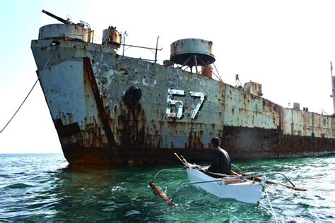 An islander from the Spratly Islands approaches the wreck of the ...