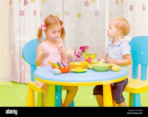 Two cute kids painted traditional Easter symbol, having fun at home ...