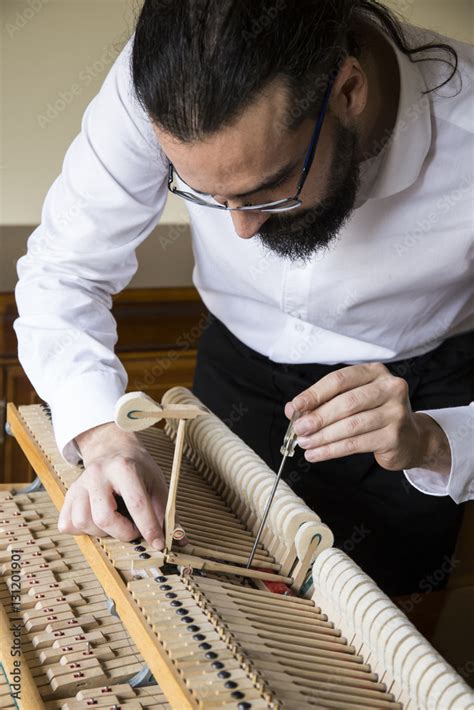 Piano tuner tuning grand piano Stock Photo | Adobe Stock