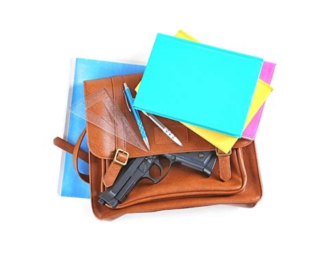 Premium Photo | School stationery and gun isolated on white