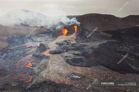 From above magma sparks out of the volcano hole and run like rivers of ...