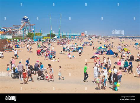 crowded busy Skegness Beach and pleasure beach amusement park Stock ...