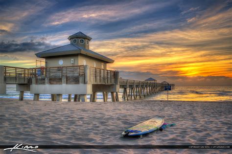 Surfboard at Juno Beach Pier During Sunrise | Royal Stock Photo