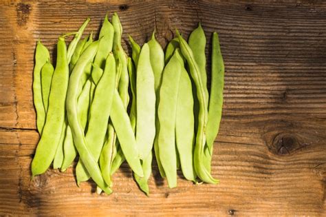 Free Photo | High angle view of fresh green hyacinth beans on wooden backdrop