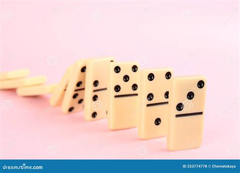 White Domino Tiles Falling on Pink Background Stock Photo - Image of ...