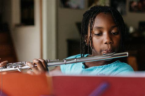 Young African American Girl Practicing Flute | Stocksy United