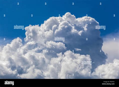 Formation of storm clouds shapes Fluffy white cumulus clouds in blue sky Summer weather Stock ...