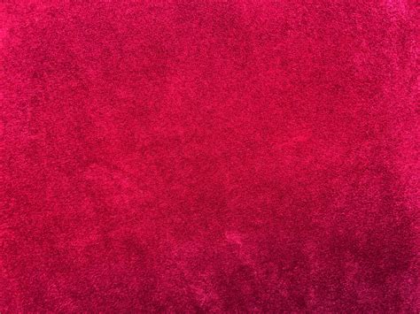 Dark red velvet fabric texture used as background. Empty dark red ...