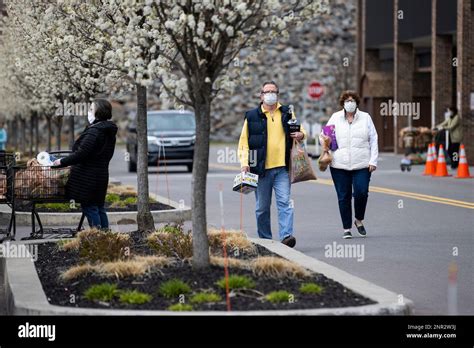 Shoppers wear face masks while leaving a Wegmans grocery store in Dickson City, Pa., Thursday ...