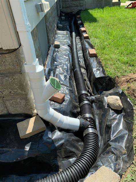 an image of a drain system installed in the ground for drainage work on a house