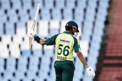 Babar Azam raises his bat after reaching his half-century ...