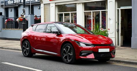 A Red Electric Car Parked on the Street · Free Stock Photo