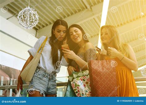 Friends Shopping Together and Using Smart Phone. Stock Image - Image of lifestyle, friend: 119506909