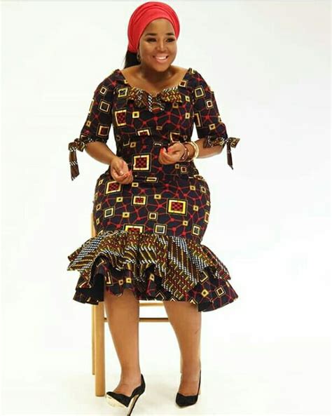 Winnie Mashaba In African Print Bodycon Layered Mermaid Dress With Red Headwrap and Black Pumps ...