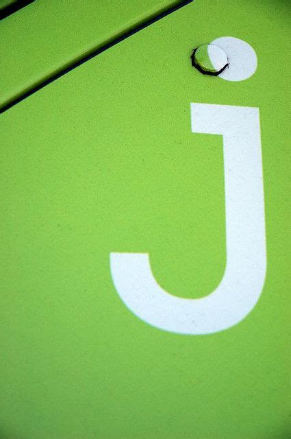 a close up of a green sign with the letter j on it