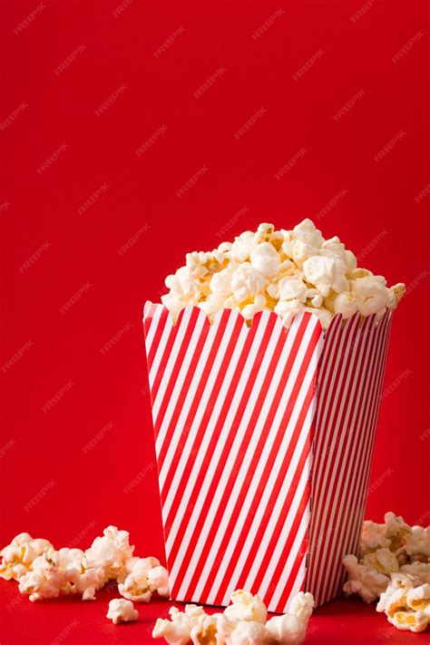 Premium Photo | Popcorn bucket with red background