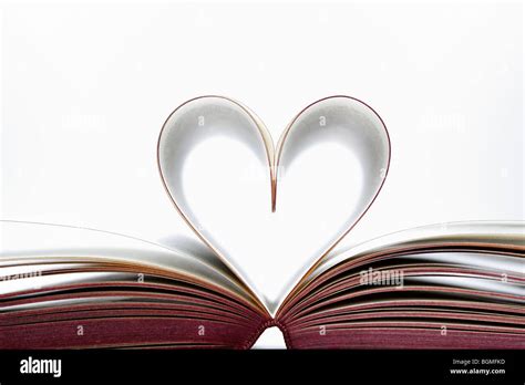 Book pages heart shaped Stock Photo - Alamy